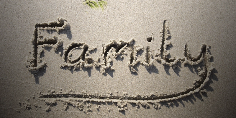 Beach sand with the word “Family” handwritten and underlined